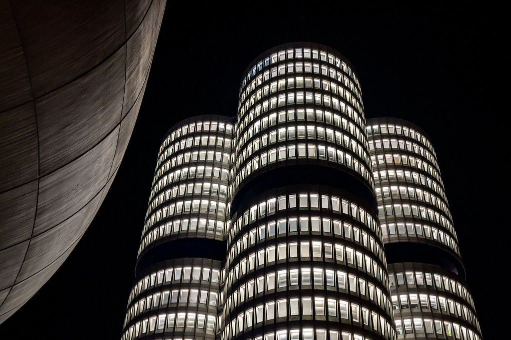 A round office tower lit up at night